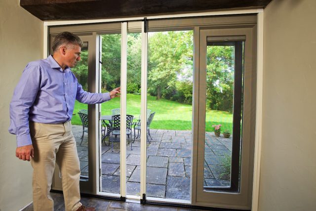 Man touching and checking insect screens