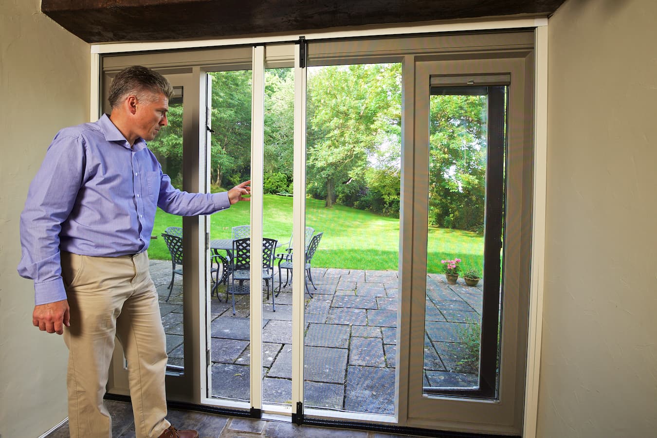 Man touching and checking insect screens